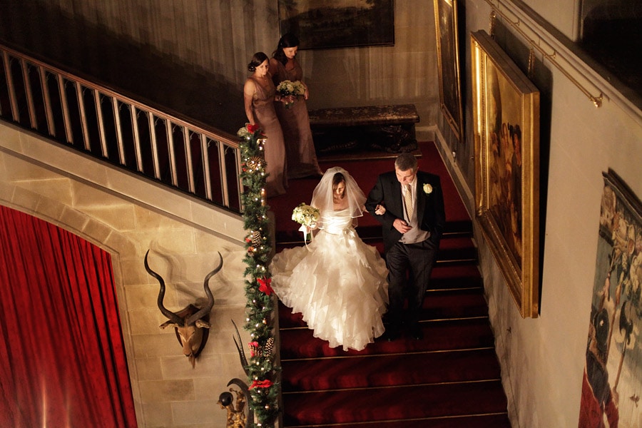 bride coming down stairs eastnor castle wedding