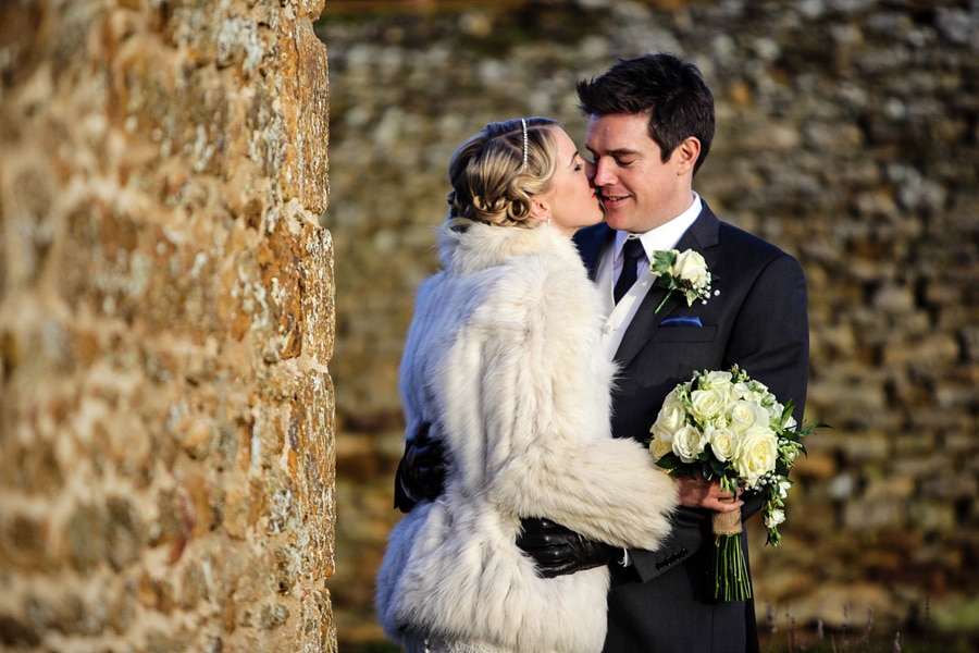 A wedding at Dodford Manor, the bride and groom enjoy the winter sun.
