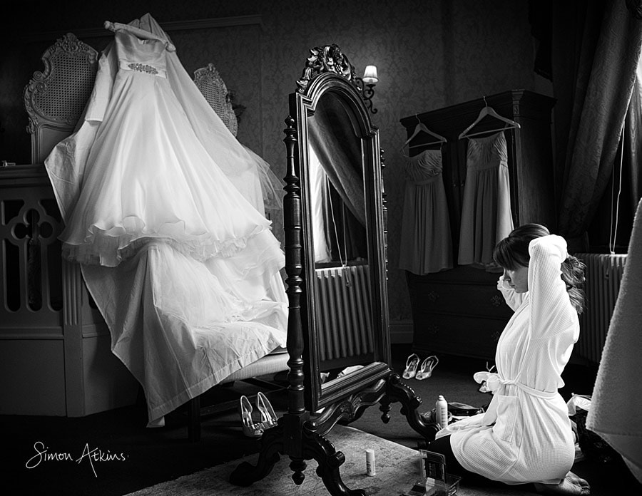 wedding photography Coombe Abbey in Coventry, the brides dress hanging up.