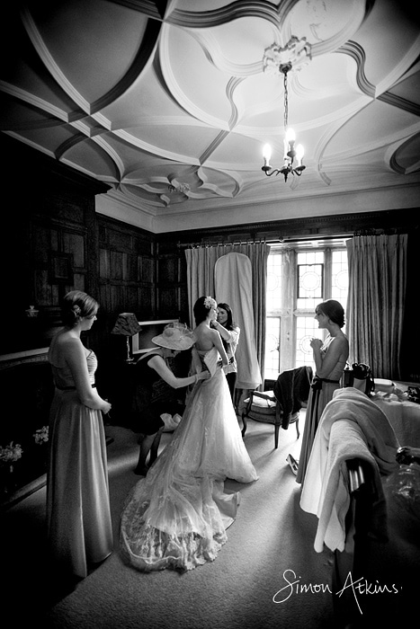bride getting into her dress at rushton hall