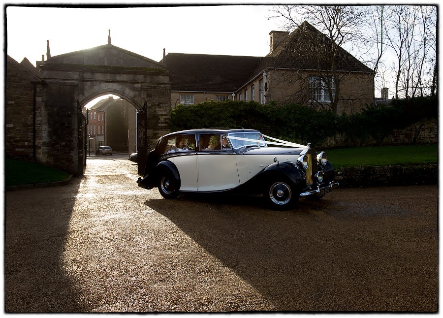 the brides car arrives for the wedding at oakham castle