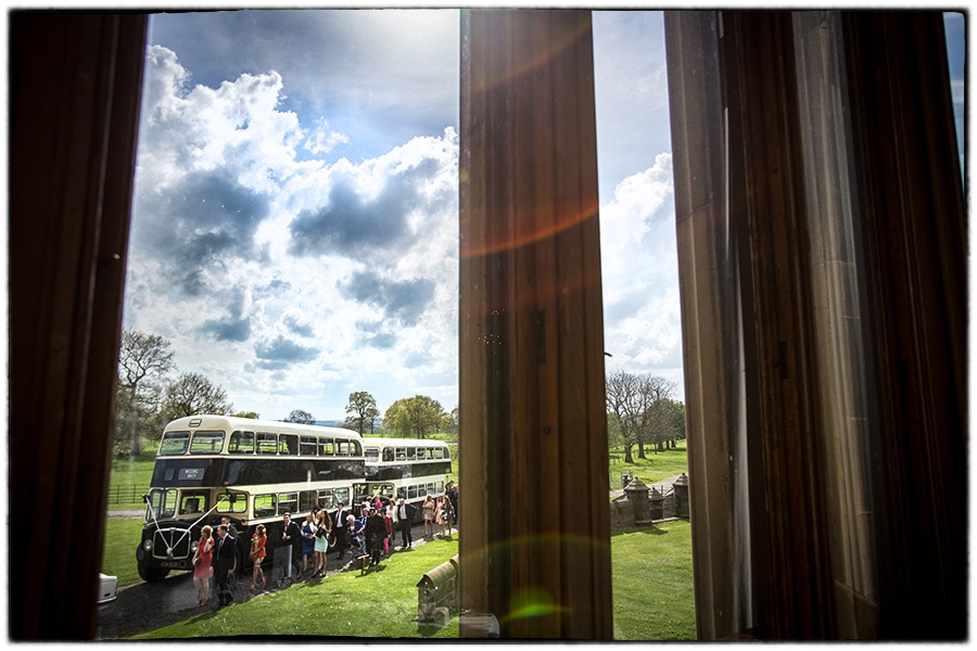 guests arrive by bus for a wedding at Allerton Castle