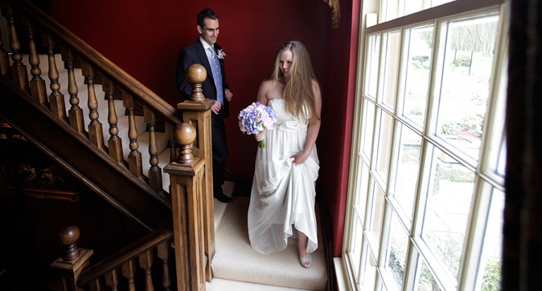 ladywood estate wedding photography with the bride and groom on the stairs