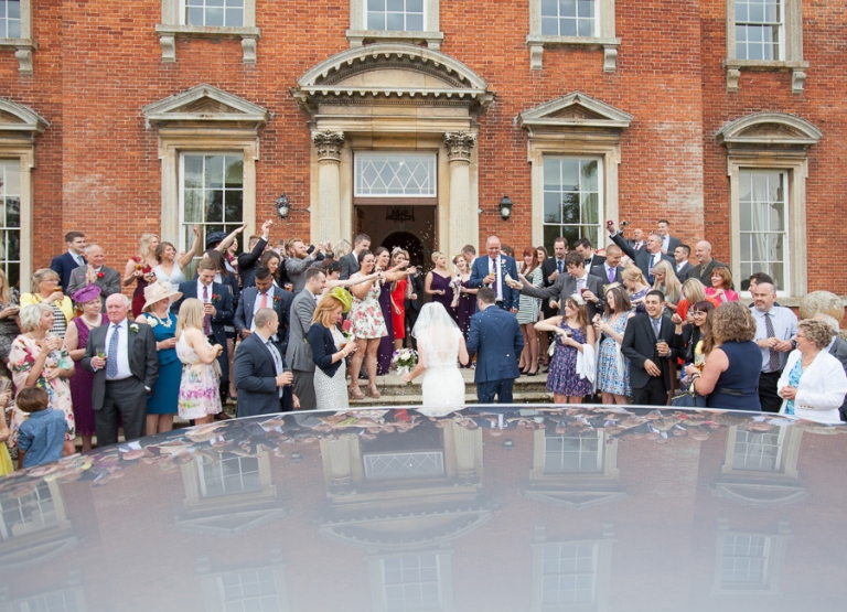 bride and groom arriving at Kelmarsh Hall