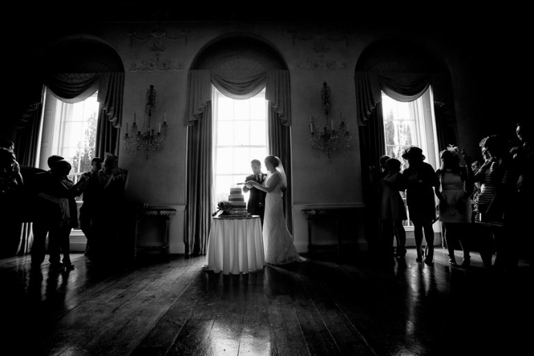 cutting the cake at a wedding at Kelmarsh Hall