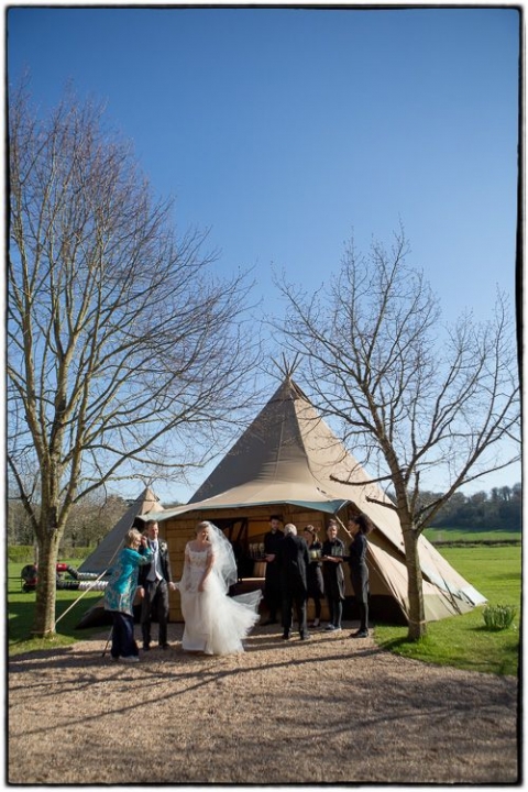 bride and groom arrive at the Tithe Barn wedding