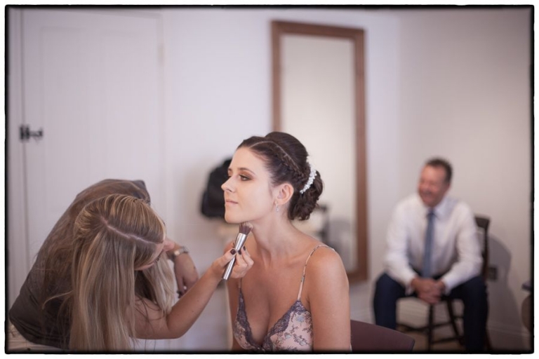 finishing touches to the brides makeup