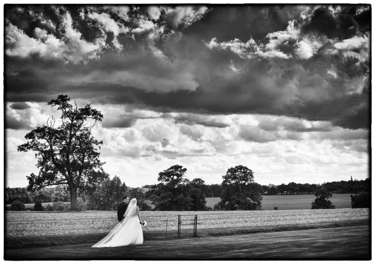 Blake Hall wedding photography with the bride and groom walking through the grounds.