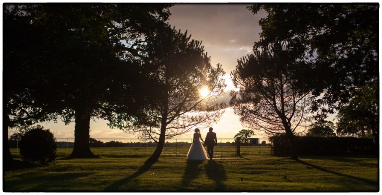 Blake Hall wedding photography, the happy couple taking a sunset walk in the grounds at Blake Hall.