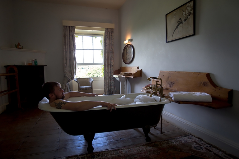 The groom takes a bath before the wedding.