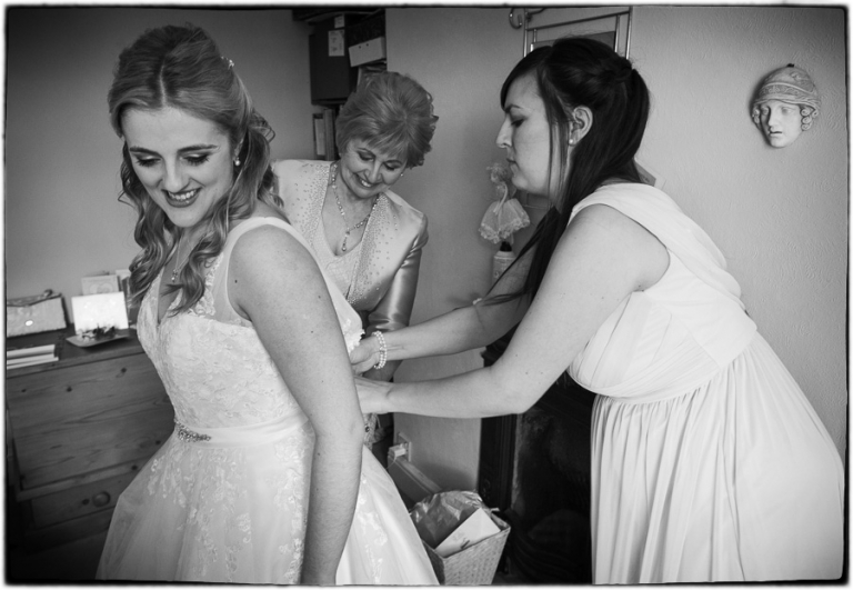 the bride getting in her dress