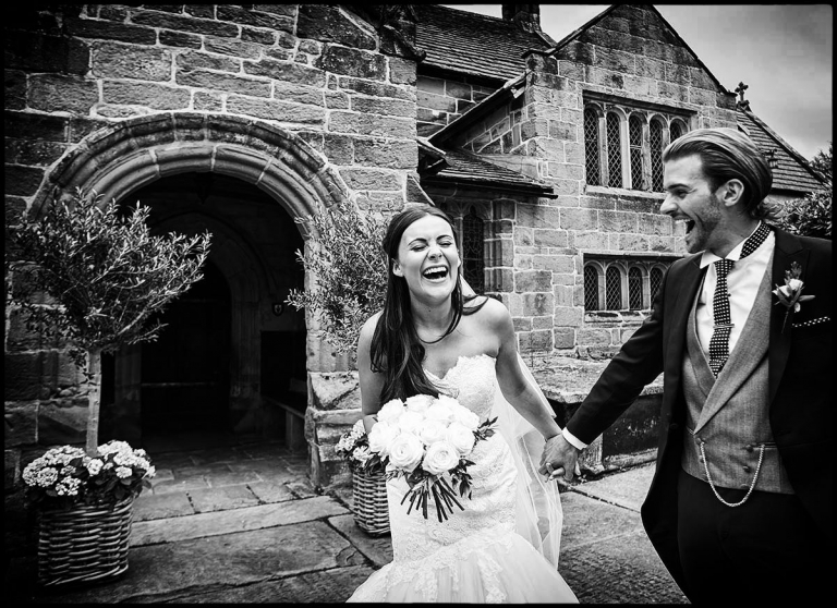 documentary wedding photographer showing the bride and groom outside a church after the ceremony