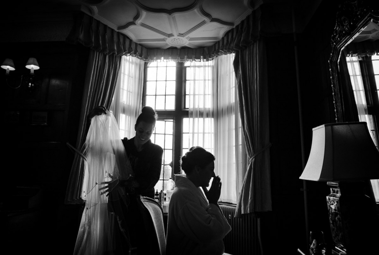 A look of delight on Joanna's face as the veil goes on