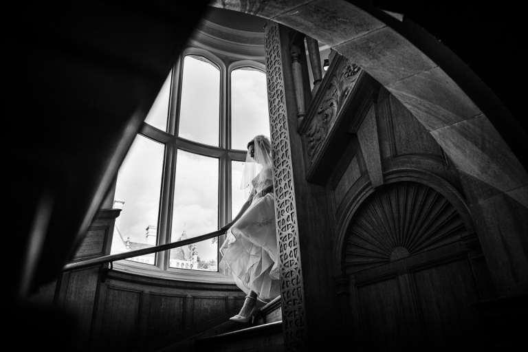 Joanna walking down the stairs for her Rushton Hall wedding