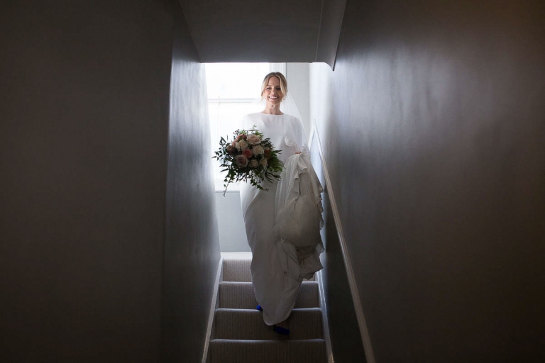 Gina coming down the stairs before heading off to the wedding ceremony