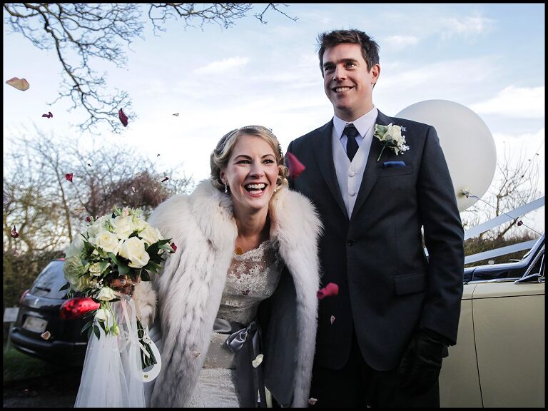 winter wedding photography with the bride and groom leaving church