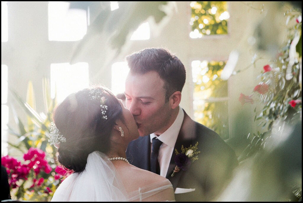 35mm film wedding, bride and groom kissing